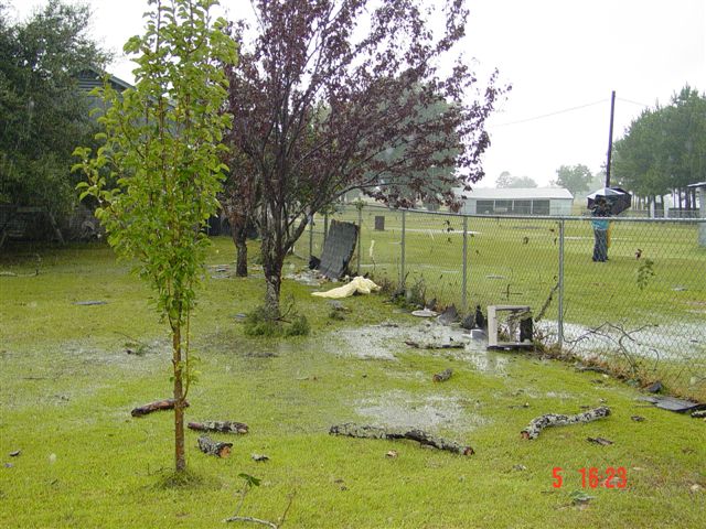 Debris blown up against the fence.